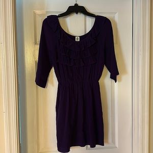 Mid length purple dress with ruffles at top and 1/4 length sleeves